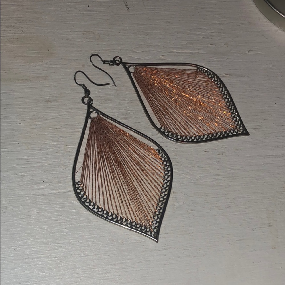 Silver earring with orange harp thread